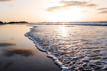 Beach shore wave at sunset