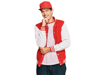 Handsome caucasian man wearing baseball uniform looking confident at the camera with smile with crossed arms and hand raised on chin. thinking positive.