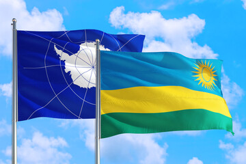 Rwanda and Antarctica national flag waving in the windy deep blue sky. Diplomacy and international relations concept.