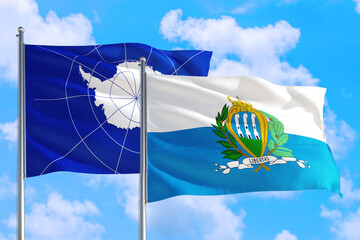 San Marino and Antarctica national flag waving in the windy deep blue sky. Diplomacy and...