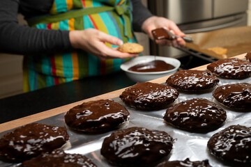 women covering cookies with coverture