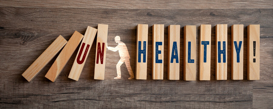 Pieces of wood with Healthy and Unhealthy on wooden background