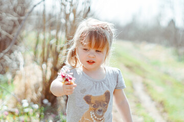 a girl holds a flower in her hands