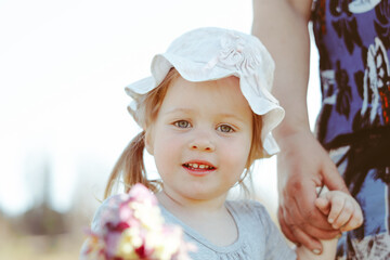 a girl holds a flower in her hands