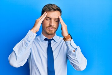 Handsome caucasian man wearing business shirt and tie suffering from headache desperate and stressed because pain and migraine. hands on head.