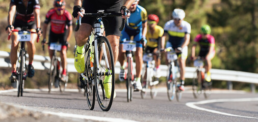 Fototapeta na wymiar Cycling competition, cyclist athletes riding a race, detail cycling shoes