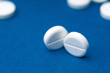 Fototapeta na wymiar medical pills close up on a blue background
