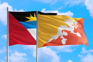 Bhutan and Antigua and Barbuda national flag waving in the windy deep blue sky. Diplomacy and international relations concept.