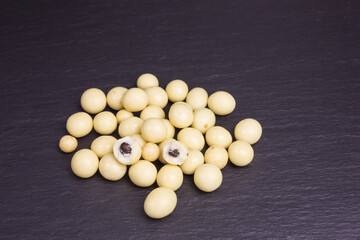Fototapeta na wymiar heap of white chocolate balls with coffee beans