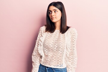 Young beautiful girl wearing casual clothes standing over isolated pink background