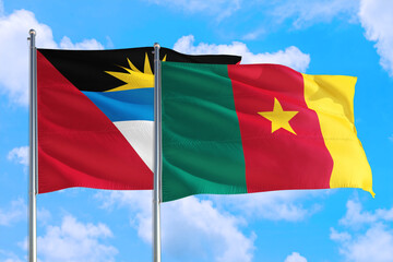 Cameroon and Antigua and Barbuda national flag waving in the windy deep blue sky. Diplomacy and international relations concept.