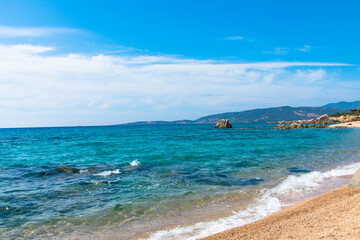 Obraz premium Empty sandy beach with mountain in the background, Beach of Propriano, Corsica, France. Place for Text