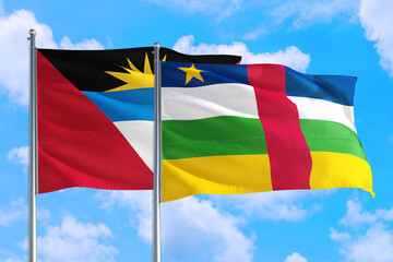 Central African Republic and Antigua and Barbuda national flag waving in the windy deep blue sky. Diplomacy and international relations concept.
