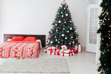 New Year's eve bedroom interior with red decor bed and Christmas tree with gifts