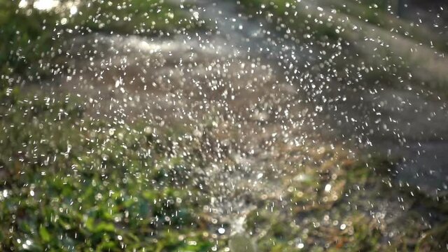 Closeup splashing water in slow motion in a daylight.