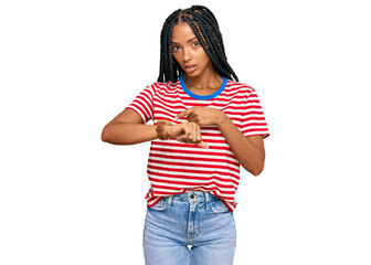 Beautiful hispanic woman wearing casual clothes in hurry pointing to watch time, impatience, upset and angry for deadline delay