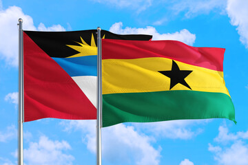 Ghana and Antigua and Barbuda national flag waving in the windy deep blue sky. Diplomacy and international relations concept.