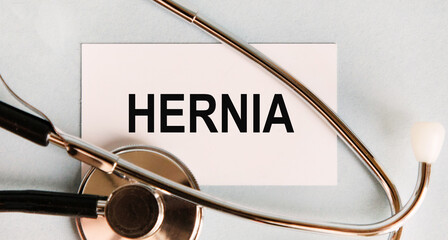 Text on the hernia business card, next to the stethop.