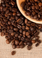 Yellow coffee cup with grains and raffia cloth background