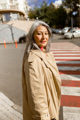 Fototapeta premium Mature pale hair stylish woman lifestyle portrait outdoors in city