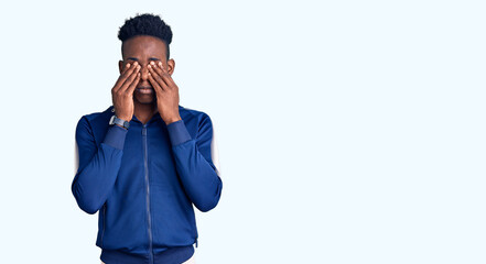 Young african american man wearing sportswear rubbing eyes for fatigue and headache, sleepy and tired expression. vision problem