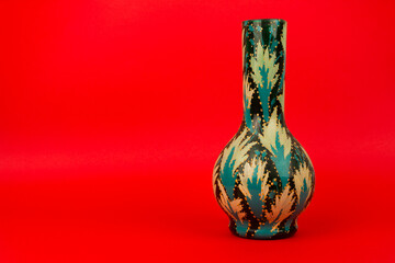 green vase isolated on red background