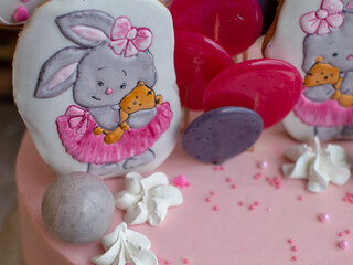 Close-up of decorations in the form of rabbits on the cake. Beautiful big gingerbread sweet number 1 on the birthday cake.