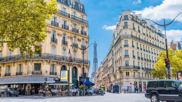 Romantic cozy view of the famous Eiffel tower from a small paris street on a cloudy autumn day with yellow gloden leaves - wide horizontal panorama.Camera zooms out