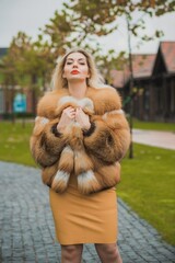 Gorgeous plus size blonde European woman in luxury fur coat, women's beauty. Concept of furs