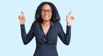Fototapeta na wymiar Young african american woman wearing casual clothes and glasses gesturing finger crossed smiling with hope and eyes closed. luck and superstitious concept.