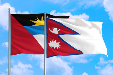 Nepal and Antigua and Barbuda national flag waving in the windy deep blue sky. Diplomacy and international relations concept.
