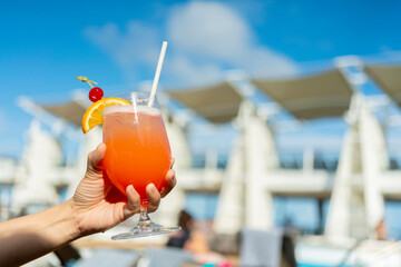 orange cocktail glasses on rattan bench at wooden cruise deck summer vacation moment relax and peaceful concept