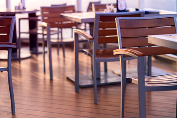 dining table and wooden chair on wooden cruise deck with nobody sunset time