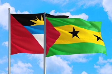 Sao Tome And Principe and Antigua and Barbuda national flag waving in the windy deep blue sky. Diplomacy and international relations concept.