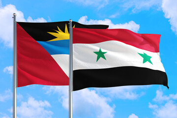 Fototapeta na wymiar Syria and Antigua and Barbuda national flag waving in the windy deep blue sky. Diplomacy and international relations concept.