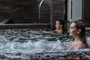 Tranquil woman in bubbling tub in spa resort