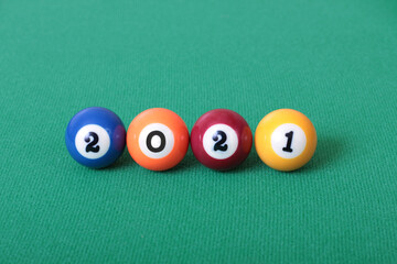 Billiard balls on green table with new year numbers