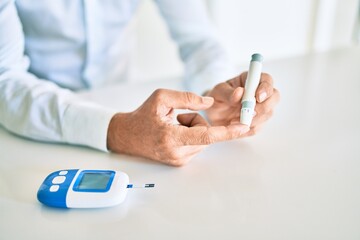 Close up of man with diabetes using insuline stick with syringe