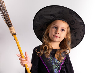  little girl in halloween costume holding a pumpkin in her hands on a white background