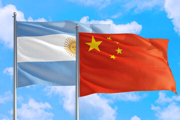 China and Argentina national flag waving in the windy deep blue sky. Diplomacy and international relations concept.