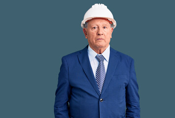 Senior handsome grey-haired man wearing suit and architect hardhat depressed and worry for distress, crying angry and afraid. sad expression.