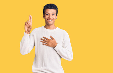 Young african amercian man wearing casual clothes smiling swearing with hand on chest and fingers...
