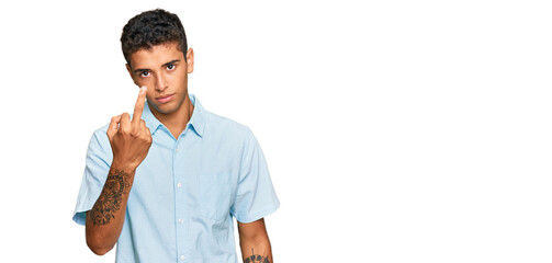 Young handsome african american man wearing casual clothes showing middle finger, impolite and rude...