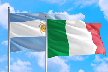 Italy and Argentina national flag waving in the windy deep blue sky. Diplomacy and international relations concept.