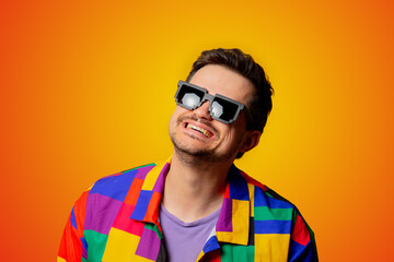 style guy in 90s shirt and pixel sunglasses on yellow background