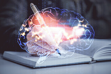 Multi exposure of woman's writing hand on background with brain hologram. Concept of brainstorming.