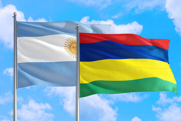 Mauritius and Argentina national flag waving in the windy deep blue sky. Diplomacy and international relations concept.