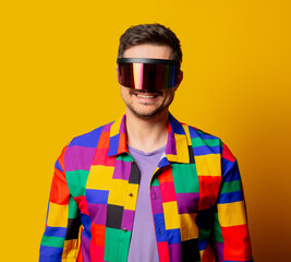 style guy in 90s shirt and futuristic glasses on yellow background