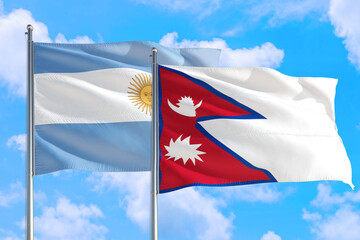 Nepal and Argentina national flag waving in the windy deep blue sky. Diplomacy and international relations concept.