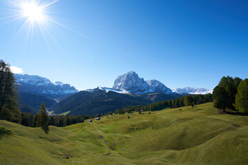 Fototapeta premium Beautiful langkofel mountain in the dolomites seen from the seceda alm with the first snow white and blue sky